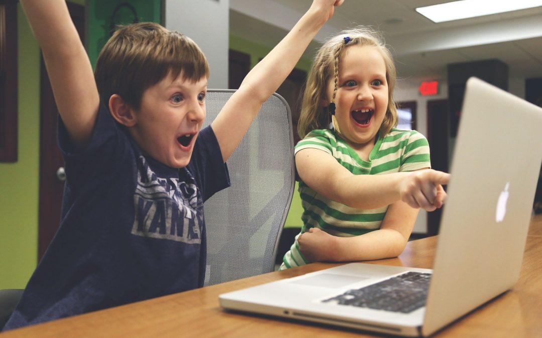 Children Cheering something on a laptop