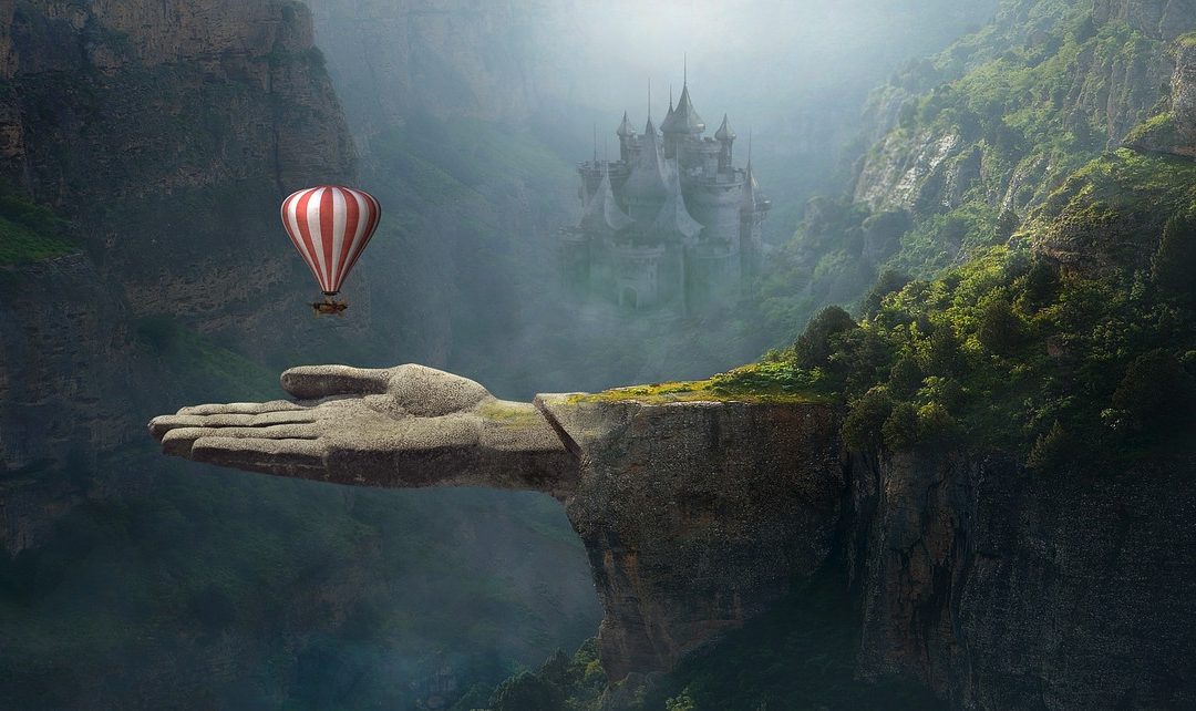 Hot air balloon flying off the edge of a cliff